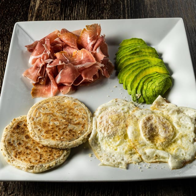GOURMET BREAKFAST (2 Eggs Prosciutto 2 Mini Arepas Sliced Avocado ).
